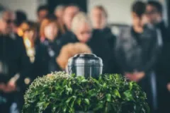 A grieving family at a funeral. Learn what a wrongful death lawyer does with our team.
