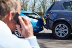 Man on the phone with an Indiana parking lot accident lawyer after crashing in a parking lot.