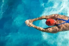 A swimmer is in a pool moments before almost drowning. By hiring a drowning accident lawyer, they could receive maximum compensation.
