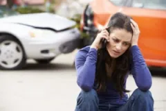 A woman calling a Valparaiso car accident lawyer after a collision.