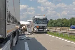 The aftermath of a semi-truck accident on a highway.