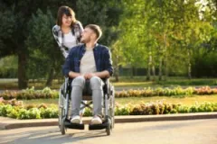 A paralyzed man and his wife. A Fort Wayne spinal cord injury lawyer can help to ensure you collect the maximum compensation.