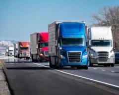 A row of trucks on a busy interstate highway. You can file a claim for compensation with a Valparaiso interstate accident lawyer.