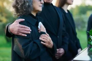 A family grieving after the loss of a loved one. A lawyer can explain the process of filing a lawsuit after a death.