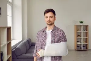 A man with a broken arm wondering about the process of suing Lyft for injuries. 