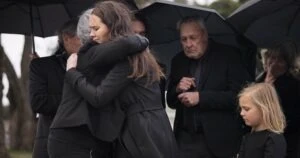 A family attends the funeral of a loved one and discusses who can file a wrongful death lawsuit.