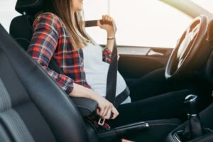 A pregnant woman is putting on her safety belt right before being hit by a negligent driver. She can hire a lawyer to represent her if she has a miscarriage after the car accident.