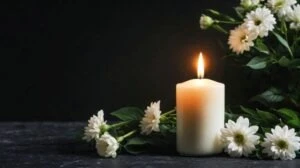 A candle and flowers at a funeral. A lawyer can explain if you can sue for wrongful death after a car accident.