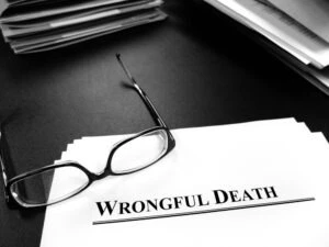 Glasses sit on top of files for a wrongful death case.