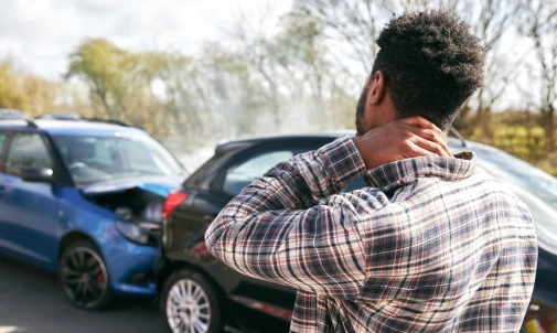 Man stands near aftermath of crash on I-80 W in Hammond and Gary, Indiana.