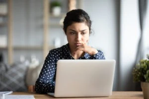 A woman on her computer researching how to file a truck accident claim in Indiana.