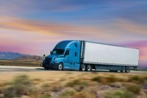 A semi-truck speeds down an interstate.