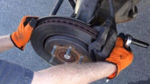 A man replaces a truck brake before a brake failure happens and causes a truck accident.