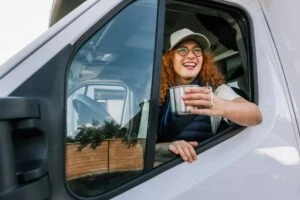 A happy woman who knows her pre-employment screening program (PSP) record will show she’s a safe trucker and eligible for a job.