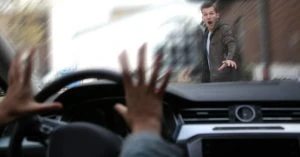 pedestrian and driver panicking as car is about to hit pedestrian