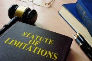 A book with the title Statute of Limitations surrounded by items in the legal profession. The book contains the limits for Florida motorcycle accident lawsuits.