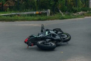 A motorcycle lies on the road while, somewhere, its rider researches Daytona Bike Week motorcycle accident lawsuits.