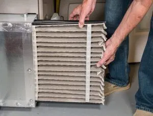 A man changing an HVAC filter
