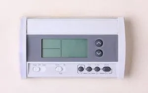 digital wall-mounted thermostat with button controls