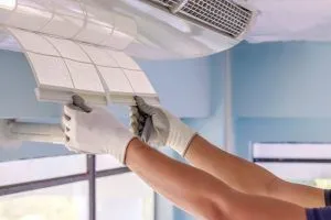hvac technician replacing air conditioning filter