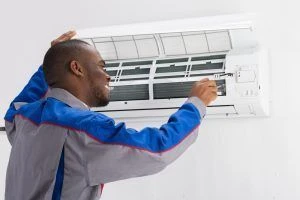 HVAC-technician-installs-replacement-AC-