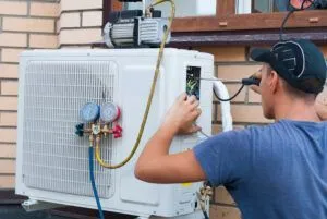 worker installing an outdoor air conditioner