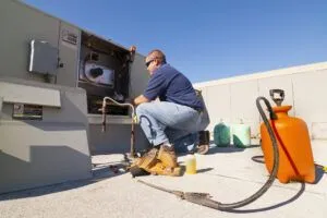 hvac tech on rooftop working
