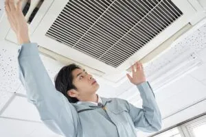 man-installing-commercial-air-conditioner