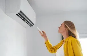 woman trying to use air conditioner