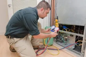 technician fixing HVAC unit