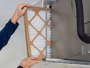 hvac service technician changing dirty indoor filter