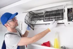 repairman cleaning indoor air filter