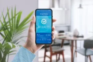 smartphone connected to indoor air quality monitor