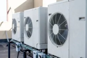 row of air conditioners sitting outside