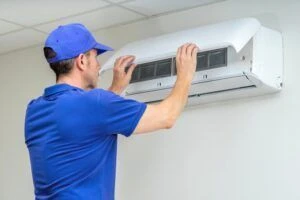 A technician servicing a commercial air conditioning unit.