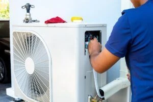 A technician working on an HVAC system after explaining what commercial HVAC is.