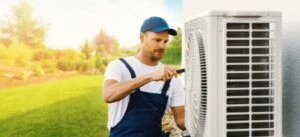 A repair technician fixing an HVAC system after explaining what is HVAC and how does it work.