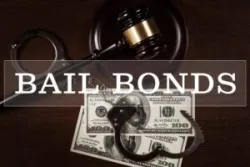 Bail bonds services concept. Judge gavel, handcuffs and money on wooden background.