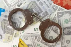 Dollar ,euro , credit cards and police handcuffs on a white background