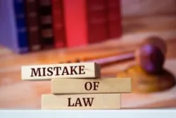 Wooden blocks with words 'Mistake of Law'.