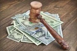 Stack Of Dollar Banknotes With Judges Or Auctioneers Gavel Or Hammer, Trial Or Tribunal Concept, Auction Concept, Close Up