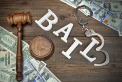 Judges Gavel, White Sign BAIL From Wooden Letters, Real Police Shabby Handcuffs And American Dollar Cash On Rough Wood Background, Top View