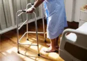 Elderly person walking with crutches