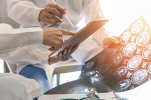 Medical experts assessing a brain injury victim's condition.