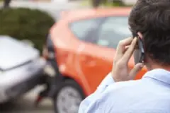 An injured driver calls a lawyer after a collision. It is worth hiring an attorney after a car accident because they can help you recover more money.