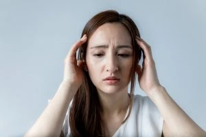 girl holding her head