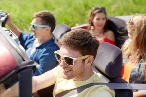 teens driving a car on a sunny day