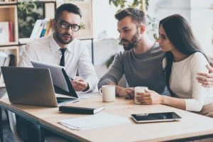 couple looking at paperwork with attorney or insurance representative