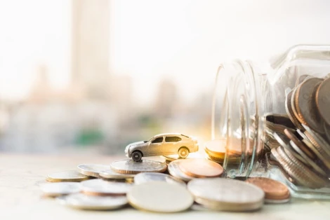 A miniature car is placed on a pile of coins spilling from a jar. An experienced car accident lawyer can determine how your award compares to the average settlement for a car accident in Georgia.