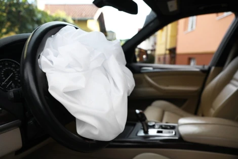 Opened Airbag in automobile, closeup. Car safety equipment